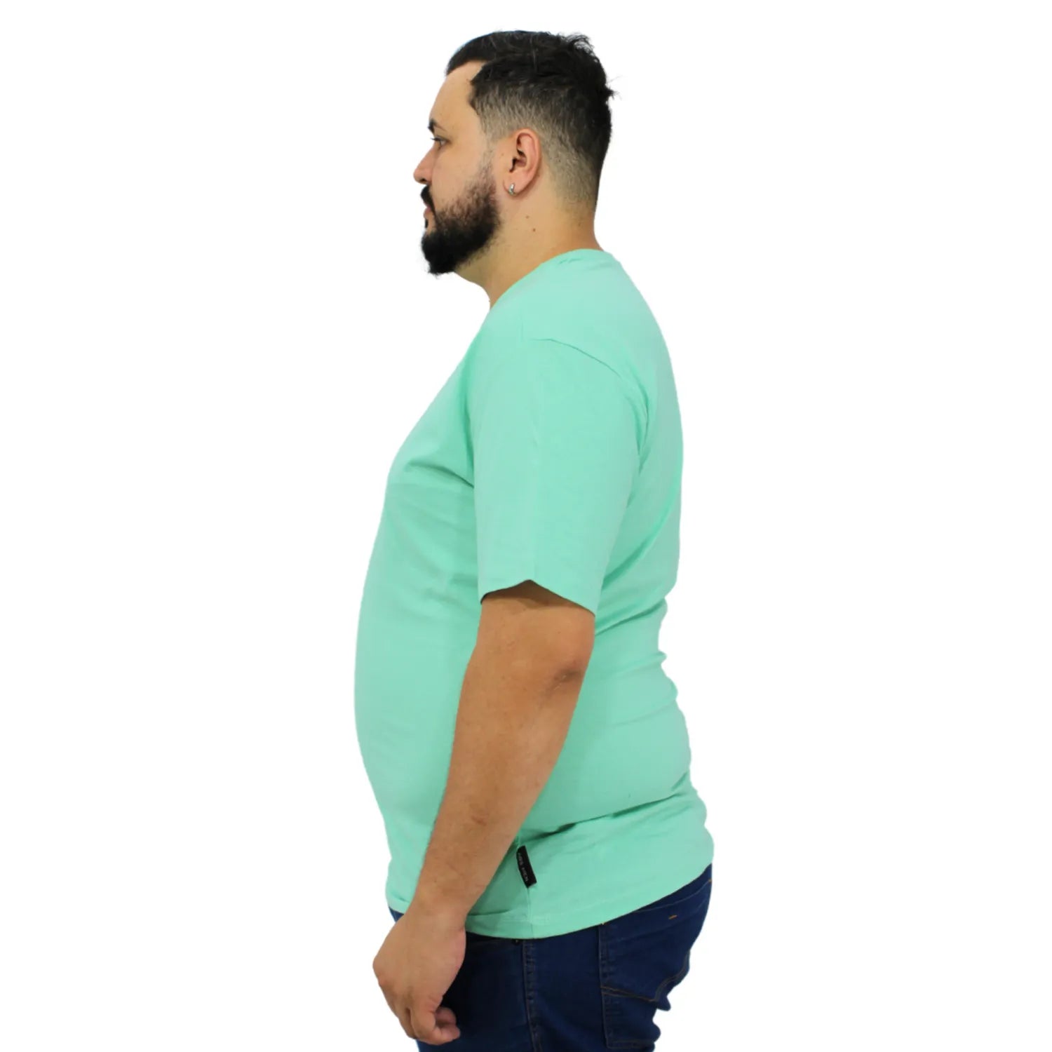 Modelo usando camiseta plus size de algodão premium da Absinto Men, com a logo da marca no peito, na cor verde.