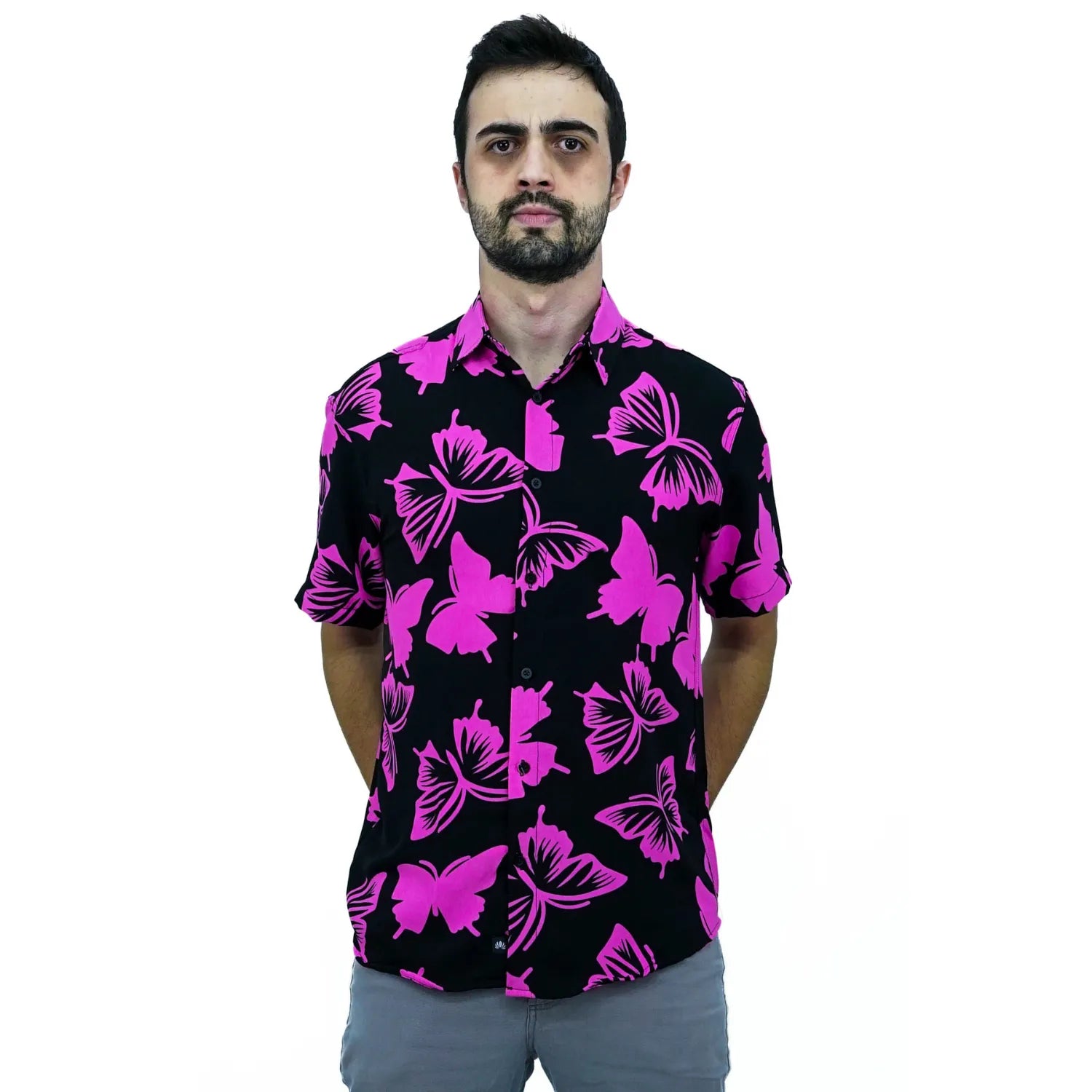 Modelo usando camisa social de viscose, de manga curta e com estampa de borboleta, na cor preto com rosa da Absinto Men.